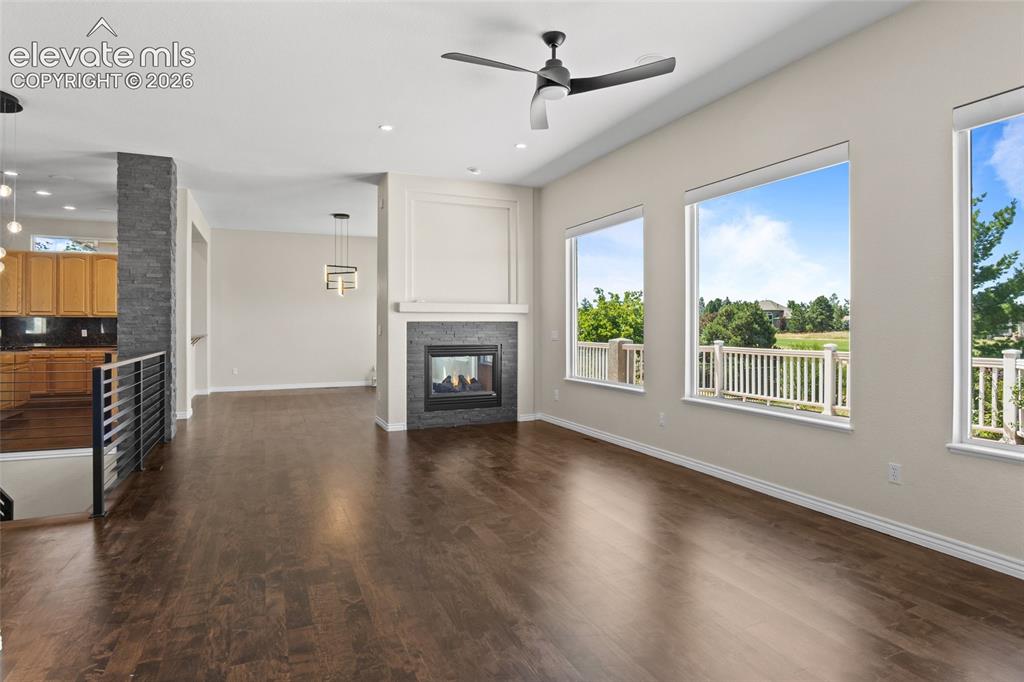 Image 9 of 50: Double Sided Fireplace beautifully enhances the complimentary spaces