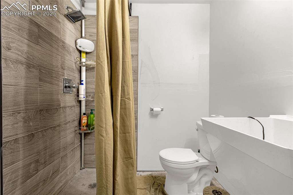 Image 31 of 38: Garage Bathroom with Shower