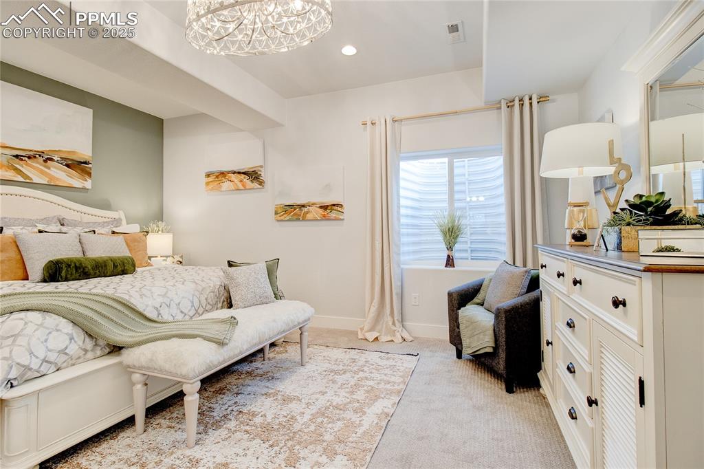 Image 16 of 26: Bedroom featuring light carpet, recessed lighting, and a chandelier