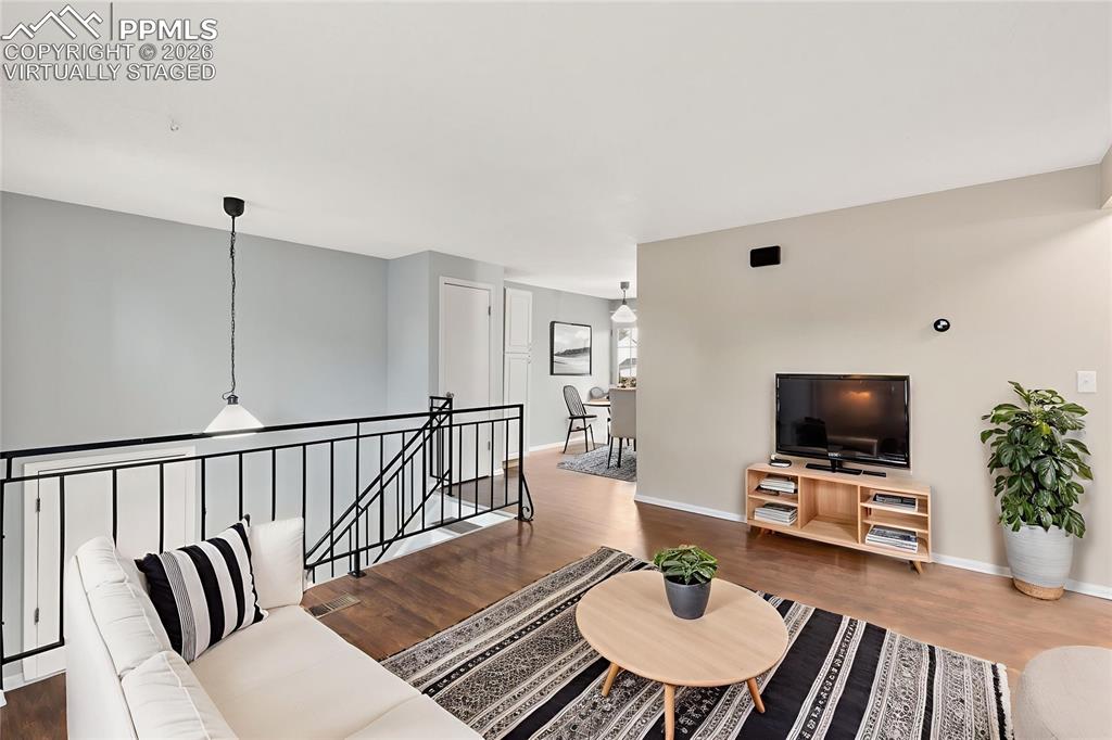 Image 5 of 22: Living room with wood finished floors, "Virtually Staged"