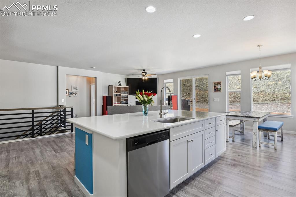 Image 14 of 47: Kitchen featuring stainless steel dishwasher, ceiling fan, a chandelier, li