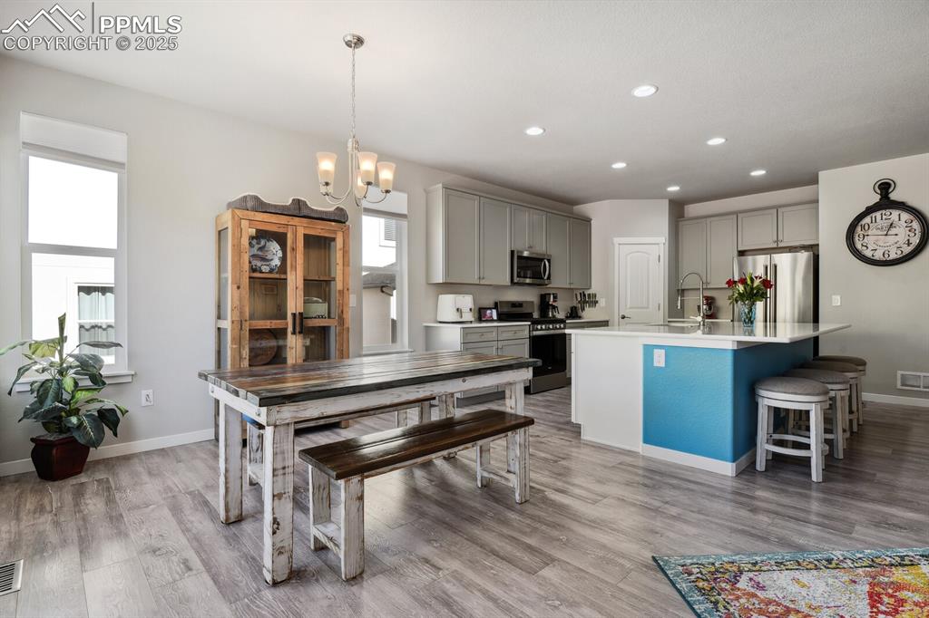 Image 16 of 47: Kitchen featuring appliances with stainless steel finishes, gray cabinetry,