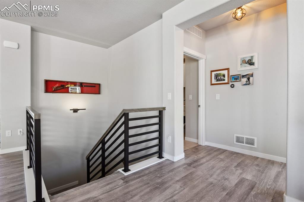 Image 23 of 47: Staircase with wood finished floors and baseboards