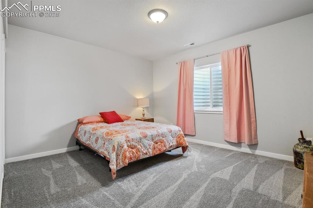 Image 36 of 47: Bedroom with carpet floors