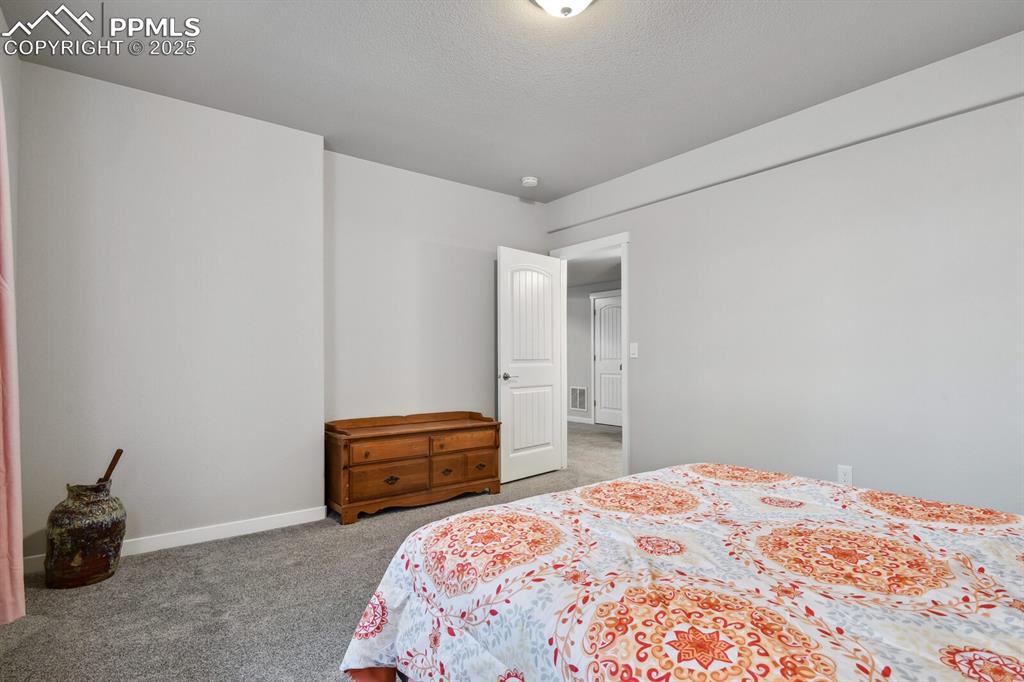 Image 37 of 47: Bedroom featuring carpet floors and baseboards