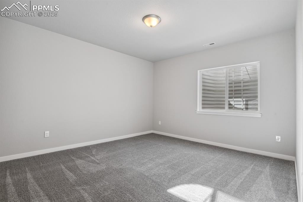 Image 38 of 47: Carpeted spare room featuring baseboards
