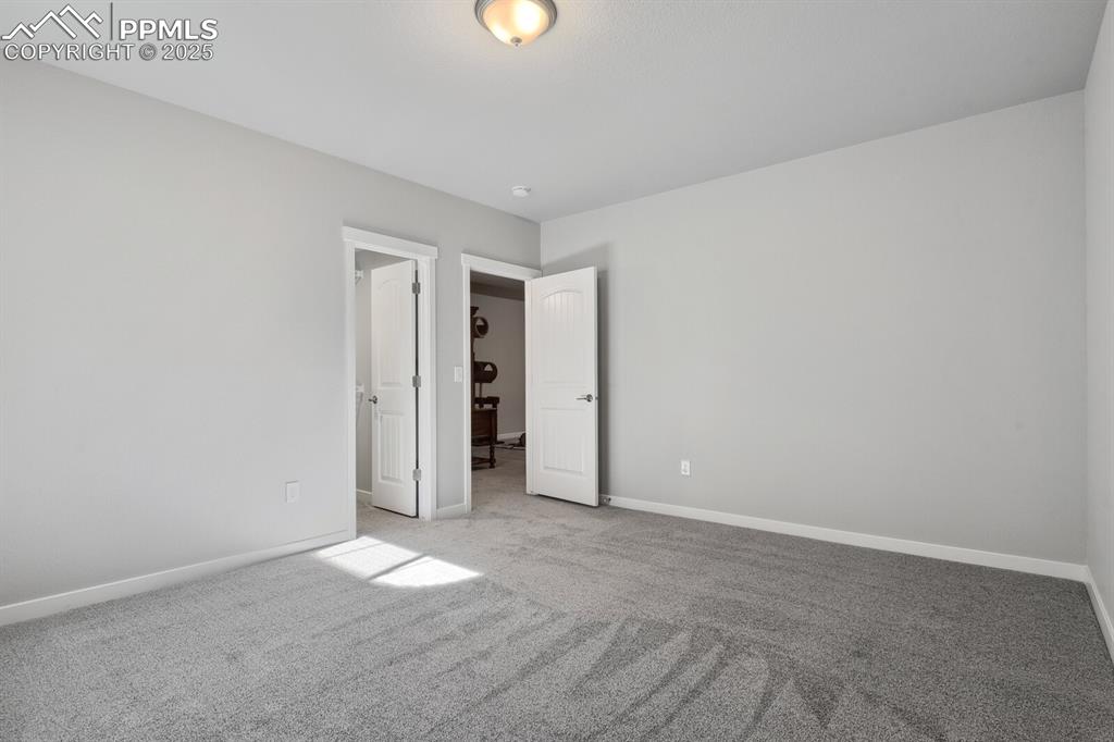 Image 39 of 47: Unfurnished bedroom with light carpet and baseboards