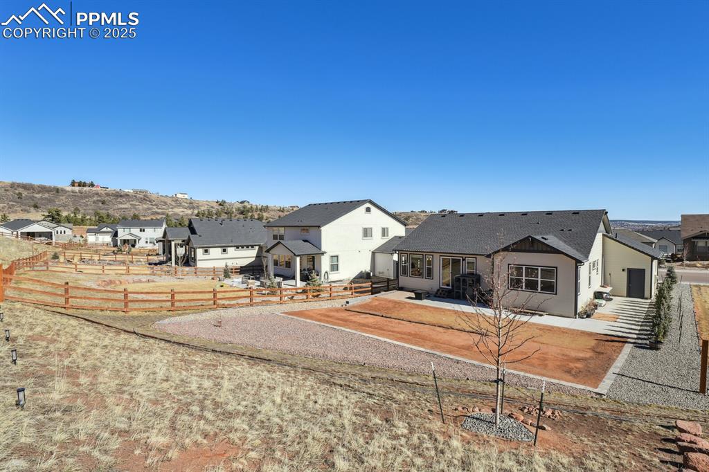 Image 41 of 47: View of front facade featuring a fenced backyard, a patio area, and a resid
