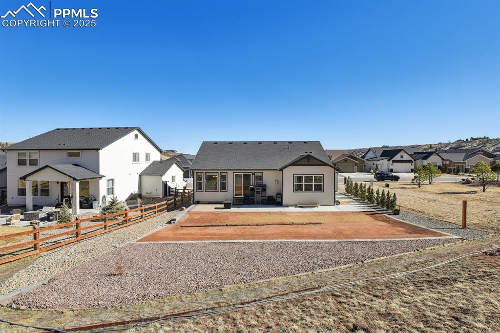 Image 42 of 47: Rear view of property featuring a patio area, a residential view, and roof
