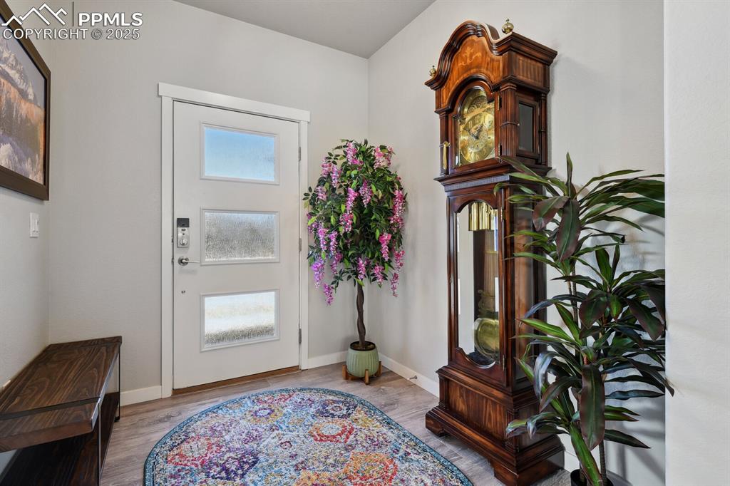 Image 5 of 47: Foyer entrance featuring wood finished floors and baseboards