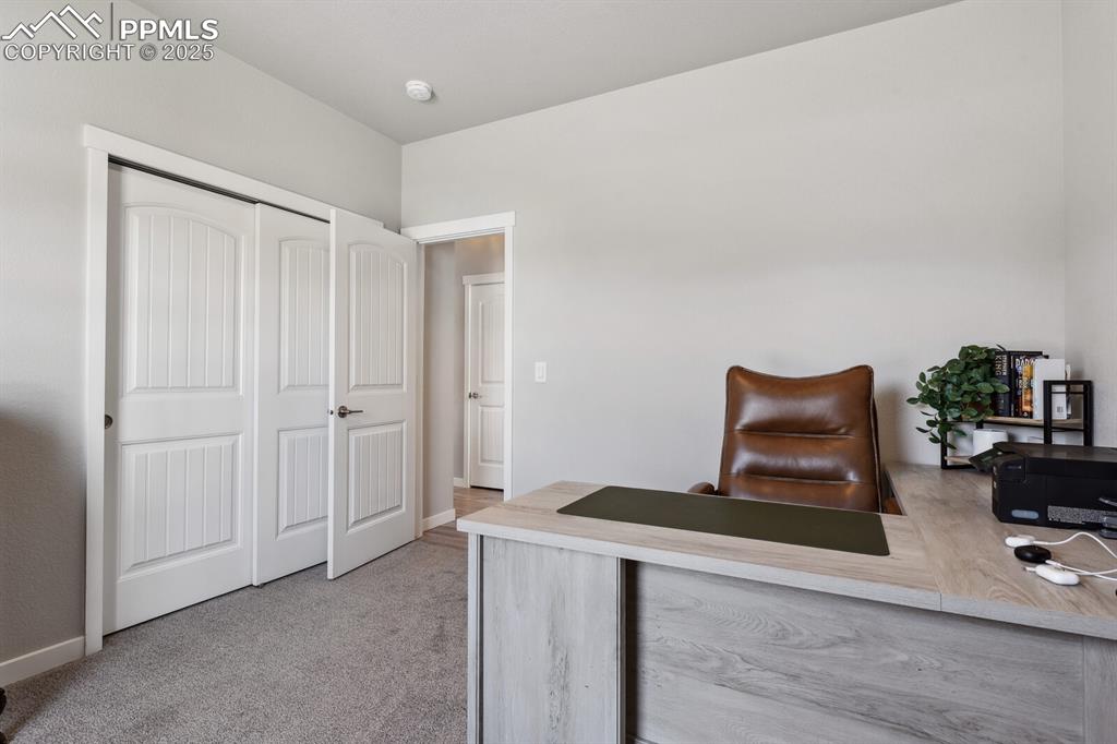 Image 8 of 47: Carpeted home office featuring baseboards