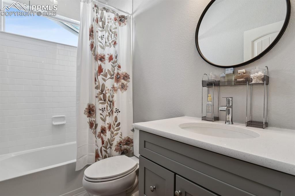 Image 9 of 47: Bathroom featuring vanity and shower / bath combo with shower curtain