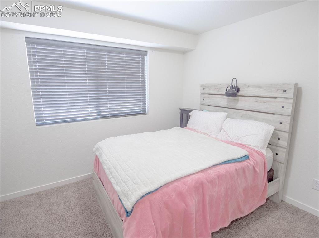 Image 12 of 30: Bedroom featuring light gray carpeting and white painted walls