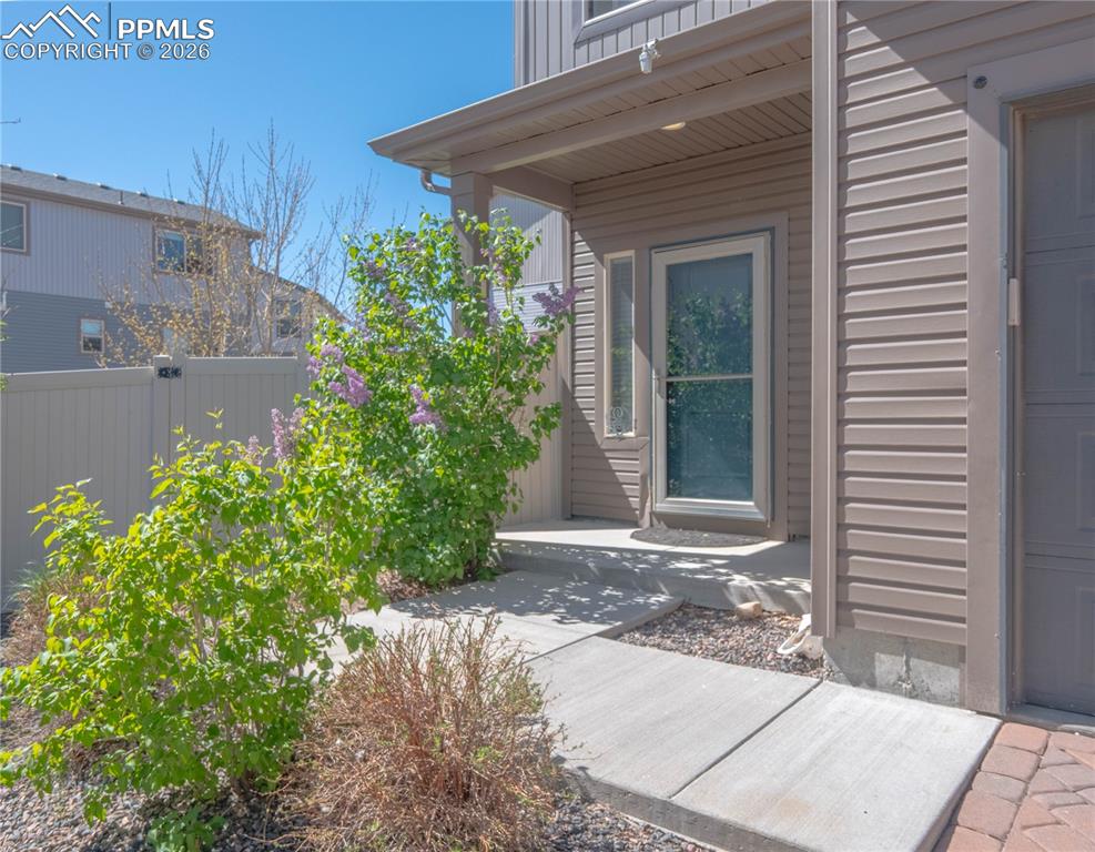 Image 2 of 30: Covered entry with horizontal siding