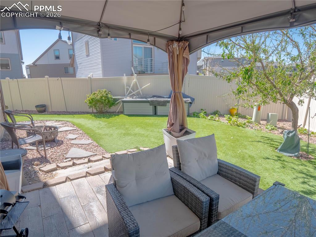Image 24 of 30: Covered patio area featuring wood-look tile flooring