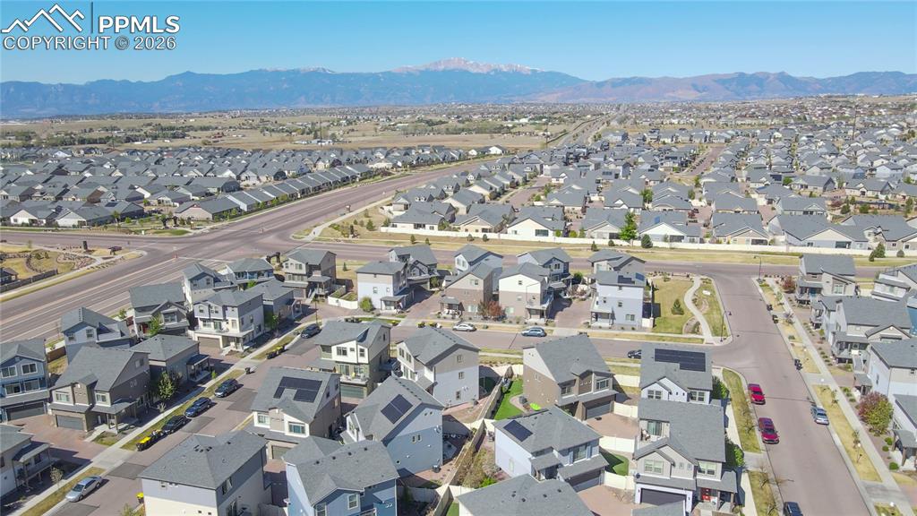 Image 28 of 30: Sprawling residential development featuring a mountain backdrop and varied 