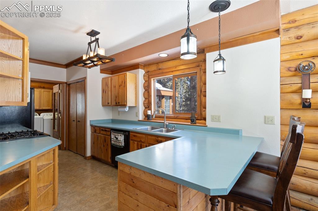Image 10 of 50: Kitchen with sink, a kitchen breakfast bar