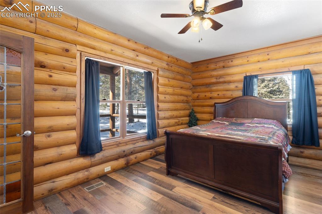 Image 8 of 50: Main level Bedroom log walls