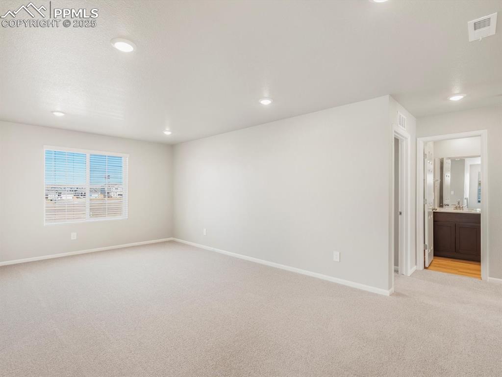 Image 14 of 27: Unfurnished room featuring light colored carpet and recessed lighting