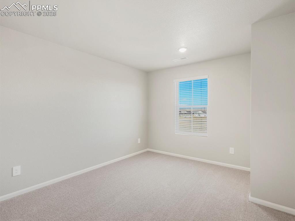 Image 16 of 27: Unfurnished room featuring baseboards and light colored carpet