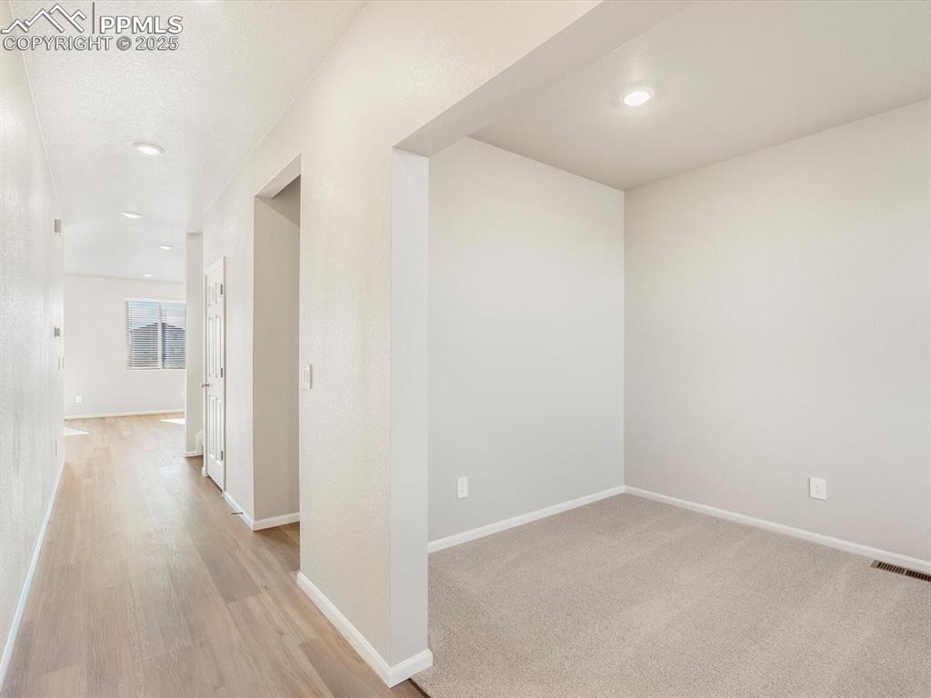 Image 2 of 27: Hall featuring recessed lighting and light wood-style floors