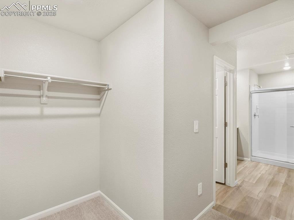 Image 22 of 27: Spacious closet featuring light wood-style floors