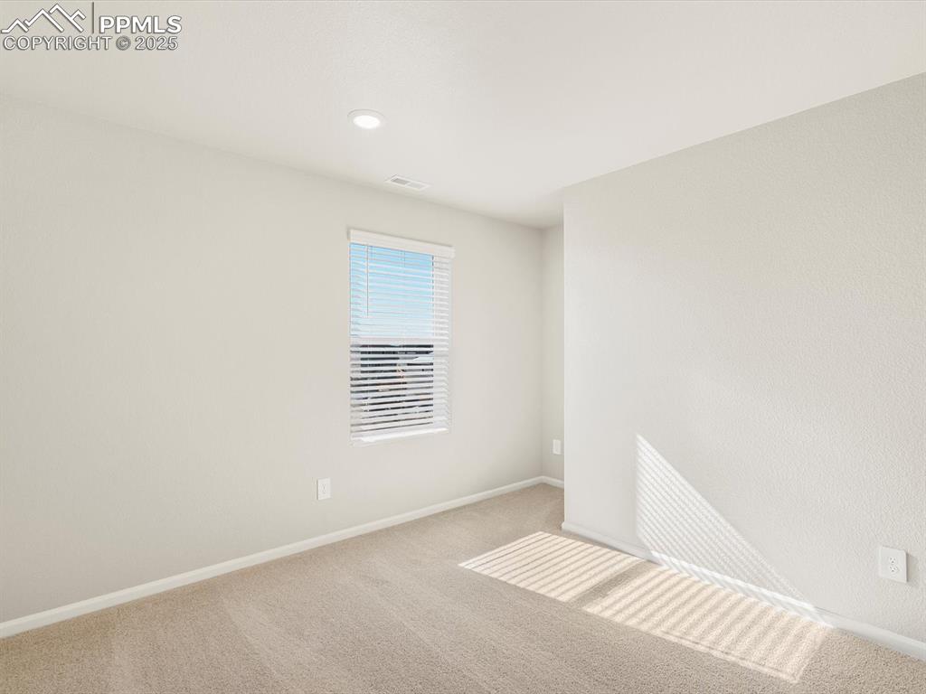 Image 25 of 27: Carpeted spare room with baseboards and recessed lighting