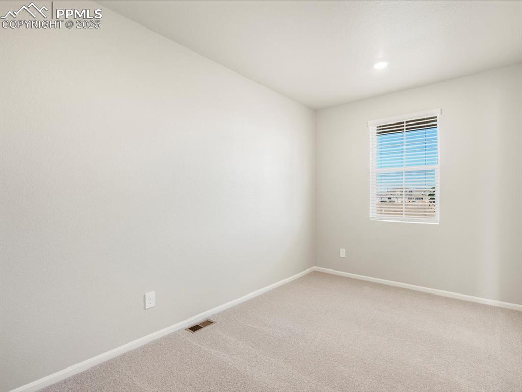 Image 3 of 27: Empty room with carpet floors and recessed lighting