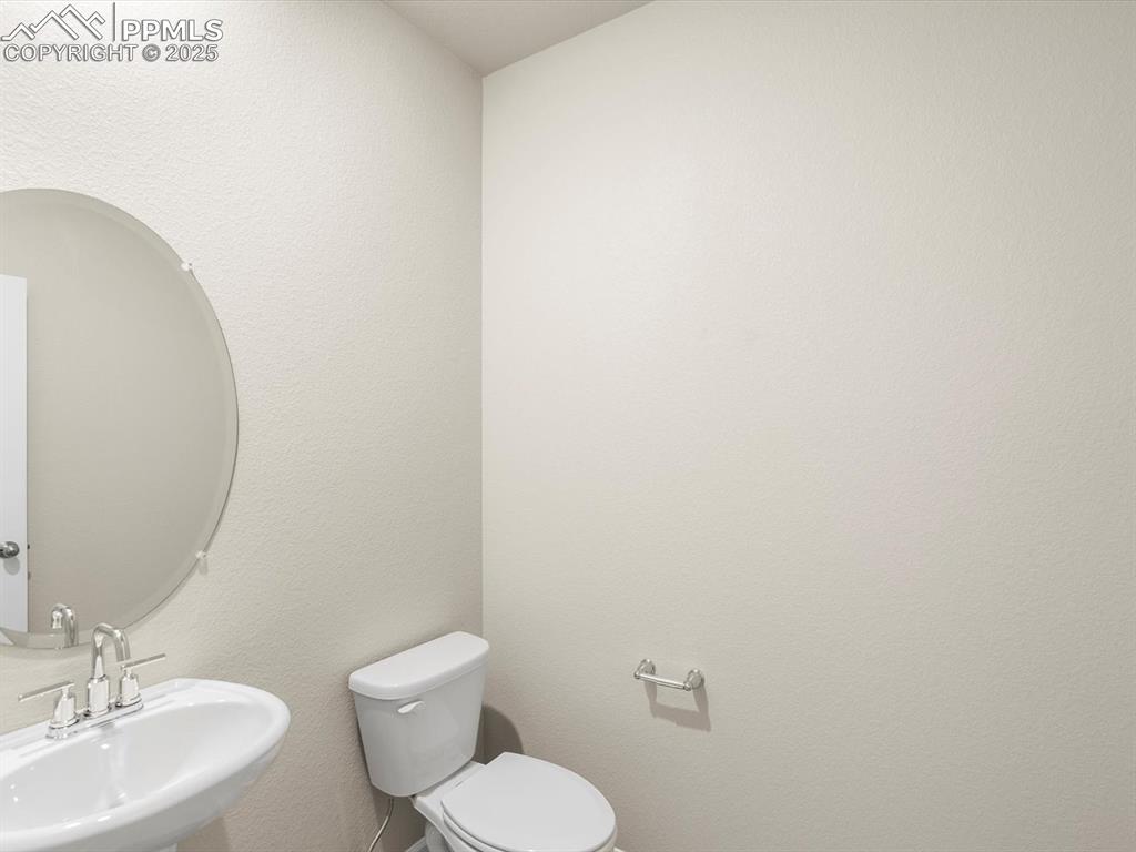 Image 4 of 27: Bathroom featuring a textured wall and a sink
