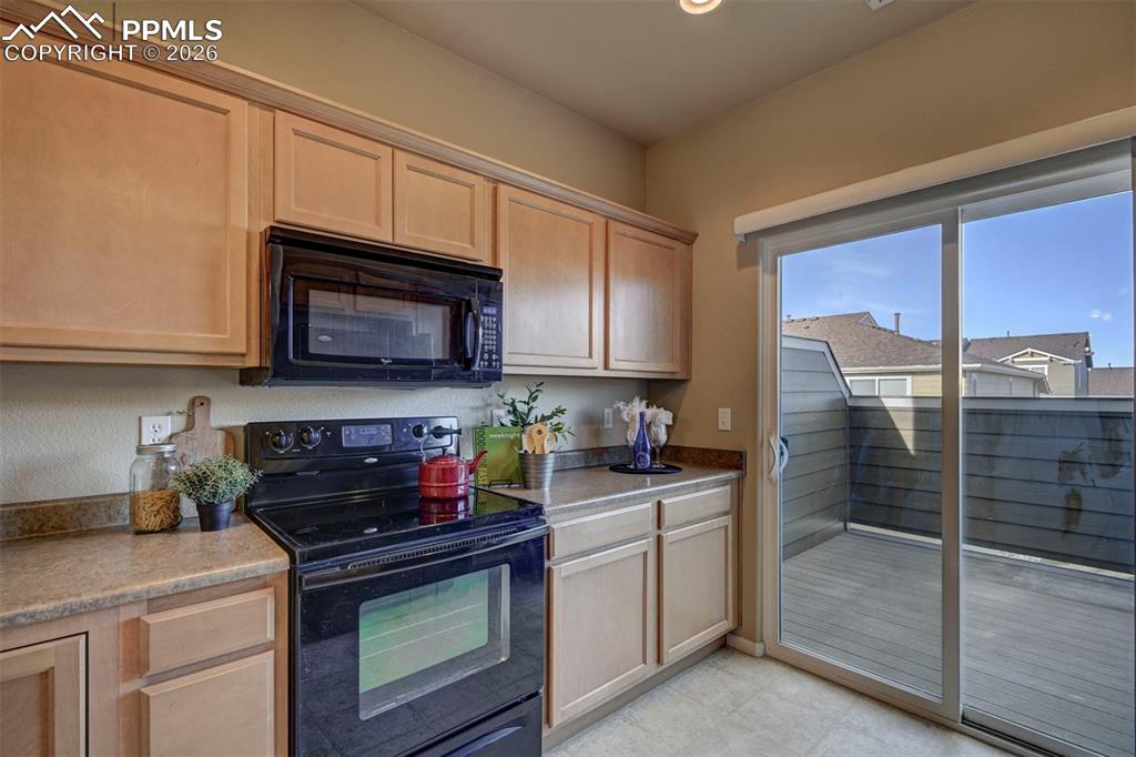 Image 16 of 44: stove top oven with built in microwave oven. Ample storage all around.