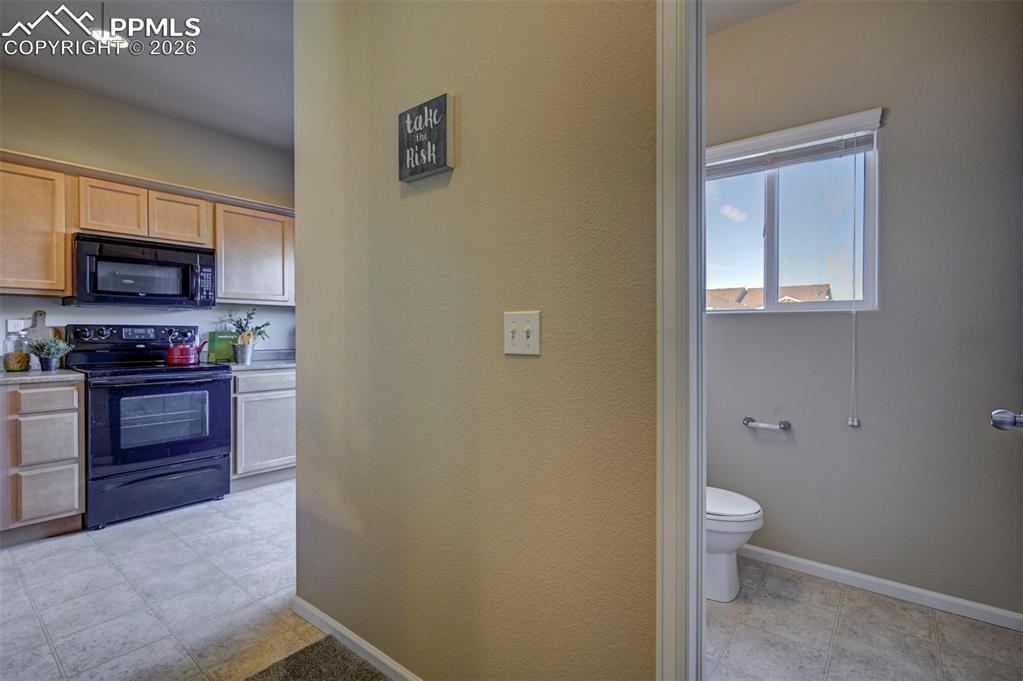 Image 22 of 44: Half bath off of kitchen and dining area.
