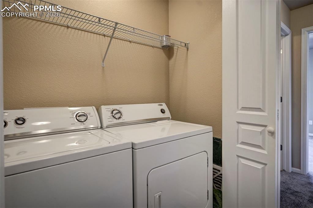 Image 26 of 44: Whirlpool washer and dryer conveniently located between primary and seconda