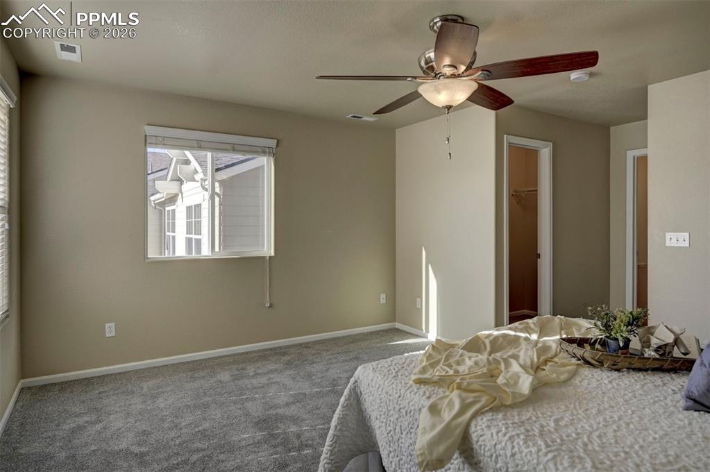 Image 33 of 44: Large walk in closet and full bathroom are connected to primary bedroom.