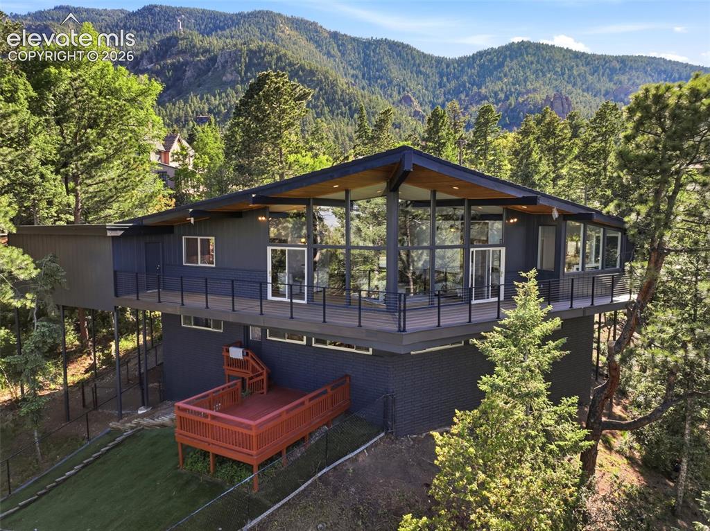 Image 1 of 48: Tucked in the pines the back deck is dreamy