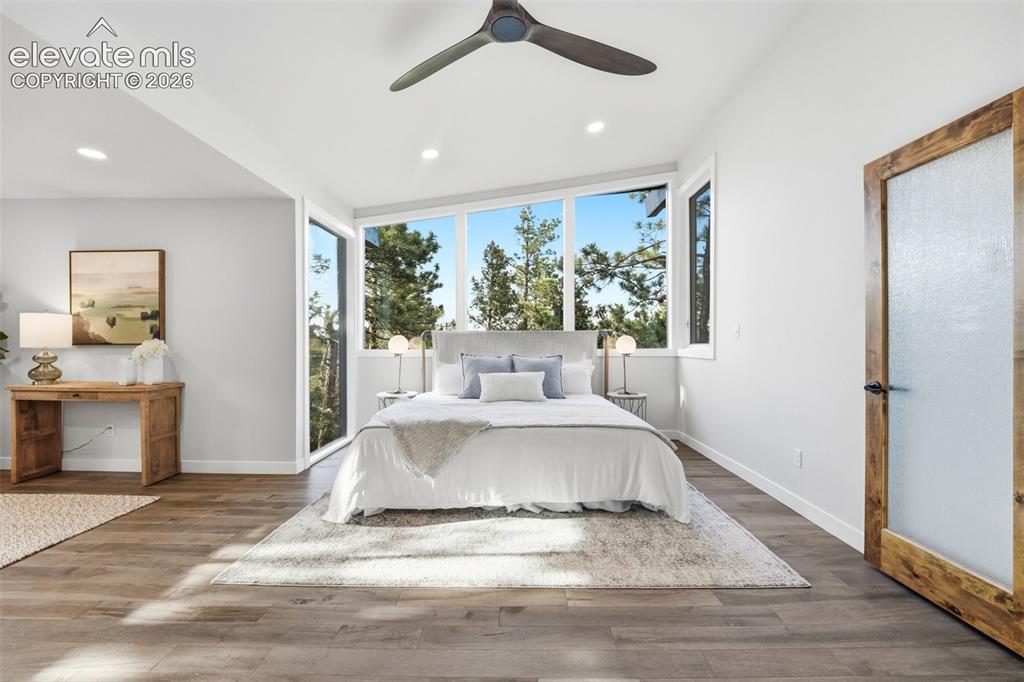 Image 22 of 48: Expansive windows frame a natural setting