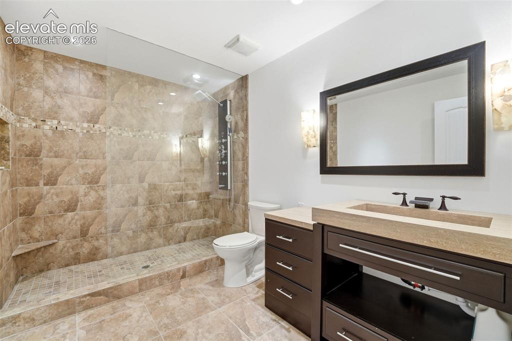 Image 34 of 48: Incredible basement bathroom spa shower