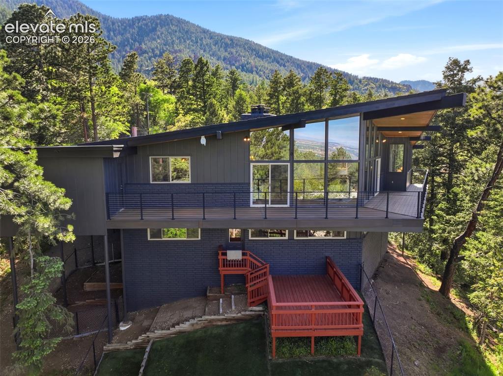 Image 46 of 48: Modern architectural exterior featuring expansive window walls