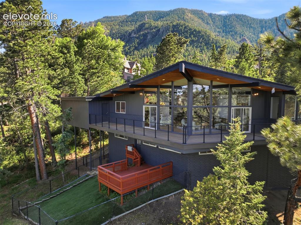 Image 47 of 48: Contemporary architectural style residence featuring extensive glazing, a s