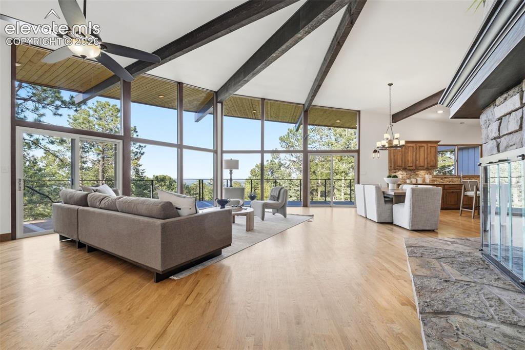 Image 6 of 48: Vaulted ceilings with exposed beams and wood-finish flooring characterize t