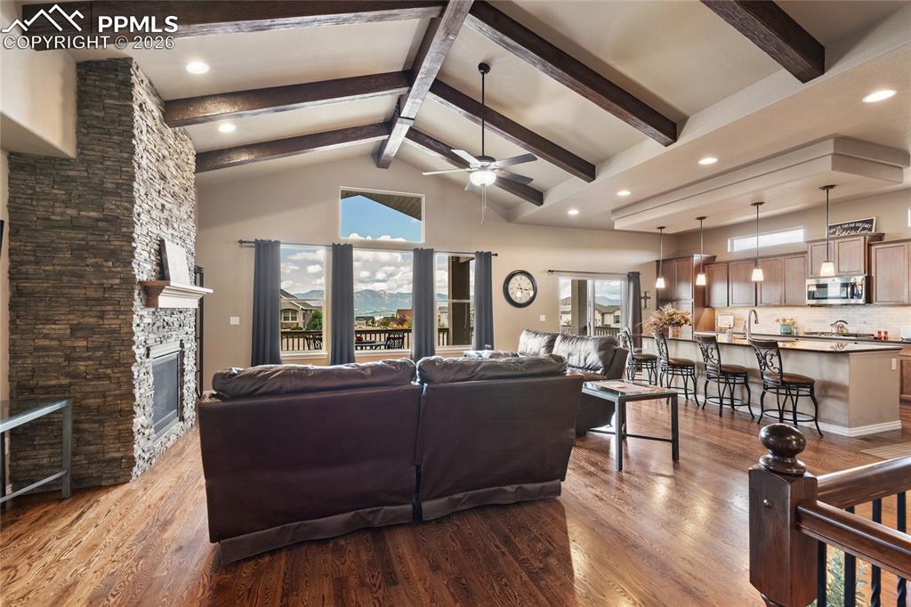 Image 13 of 49: Vaulted ceiling with accent beams and a gas fireplace.