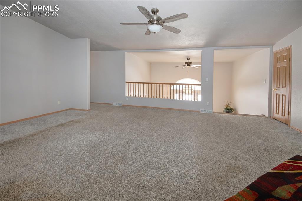 Image 12 of 50: Living room oversees foyer