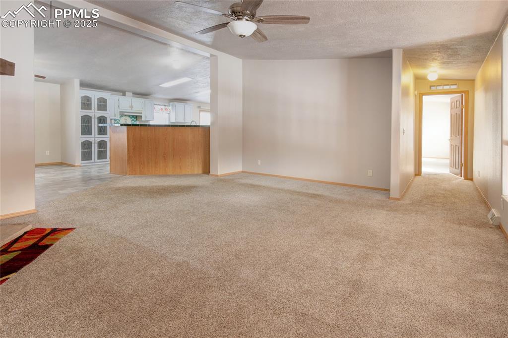 Image 14 of 50: Living room has a ceiling fan