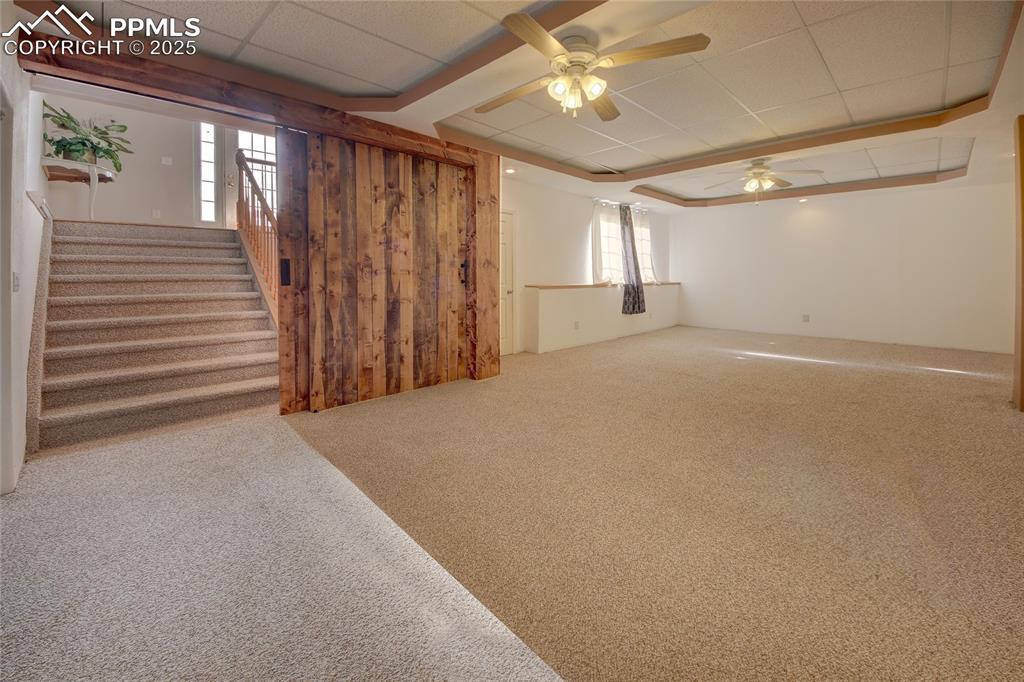 Image 31 of 50: Barndoor entry to basement family room