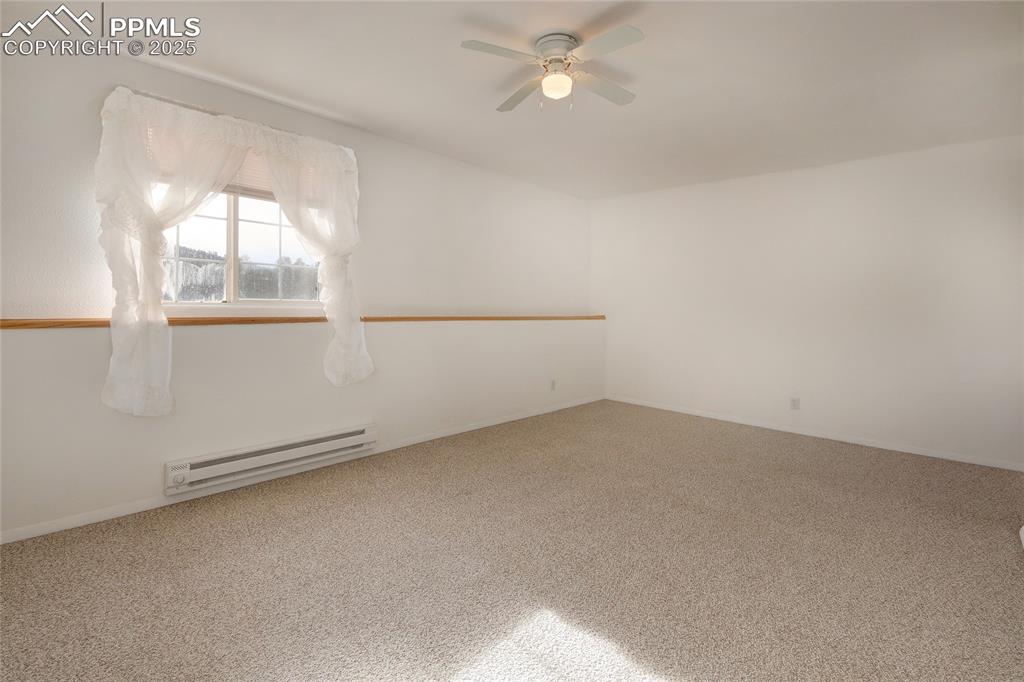 Image 36 of 50: Bedroom 4 in basement with window ledge and ceiling fan
