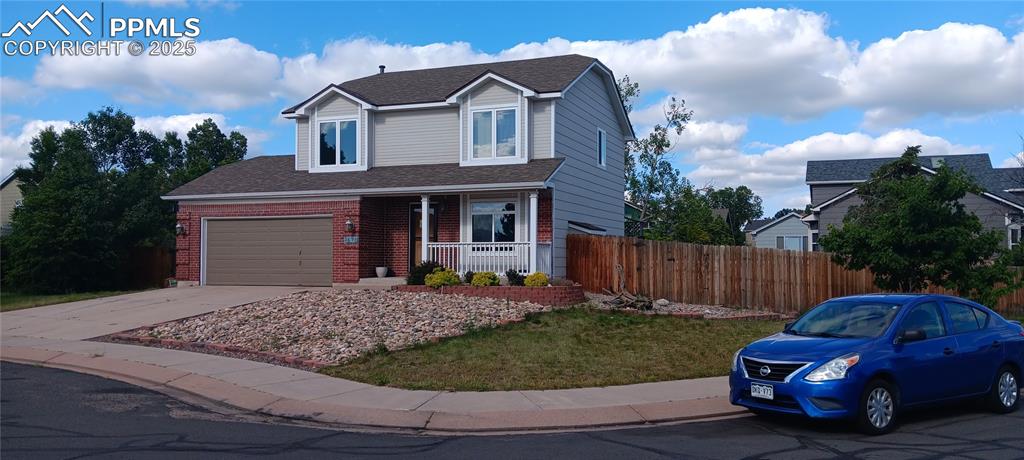 Caption: New Roof & Paint with covered porch, brick: an attached garage, and driveway facing the south (snow 