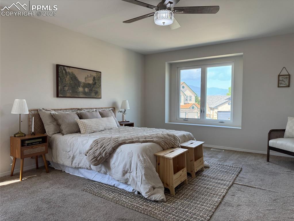Image 18 of 45: Bedroom with carpet; ceiling fan and view of mountains.