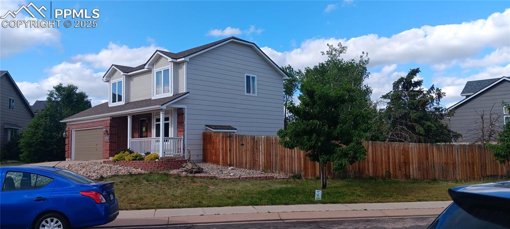 Image 2 of 45: Front yard with Oak trees - privacy fence was replaced in 2024.