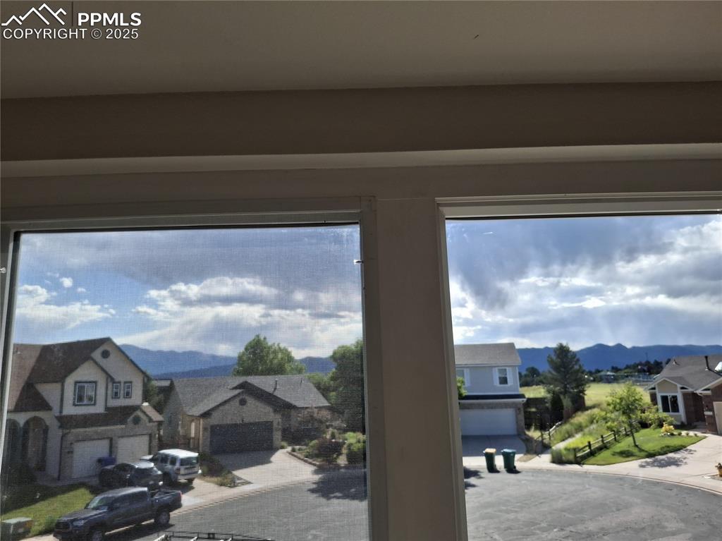 Image 31 of 45: Detailed view of a mountain backdrop and a residential view