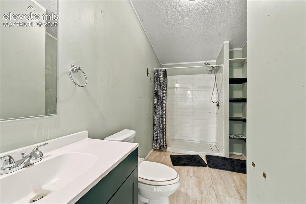 Image 10 of 19: Vanity with integrated sink, chrome faucet, and dark base cabinetry