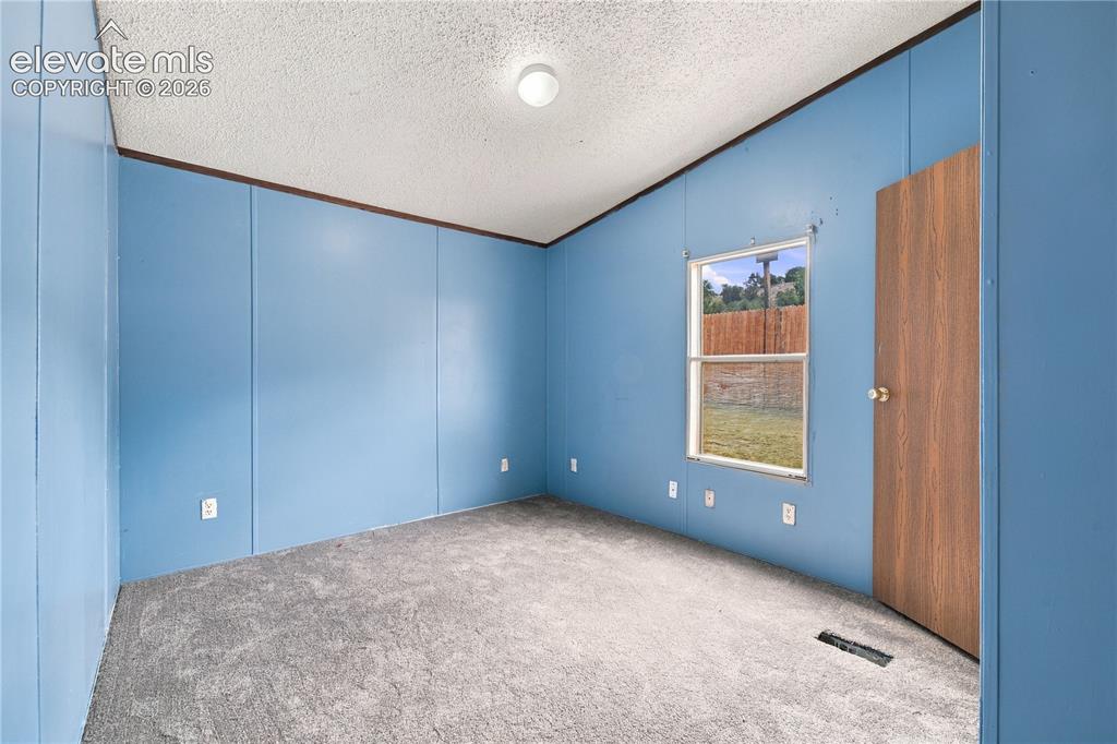 Image 11 of 19: Textured ceiling with a flush-mount light fixture